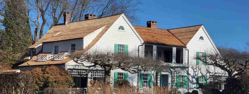 A house in Niantic, surrounded by lush trees and bushes, creating a serene and natural environment.