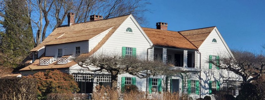 A house in Niantic, surrounded by lush trees and bushes, creating a serene and natural environment.