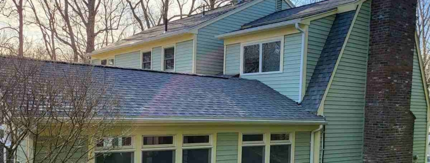 A green-sided house with a chimney, situated in Deep River.