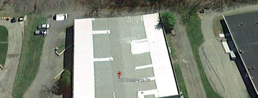 Aerial view of commercial building with flat roof.