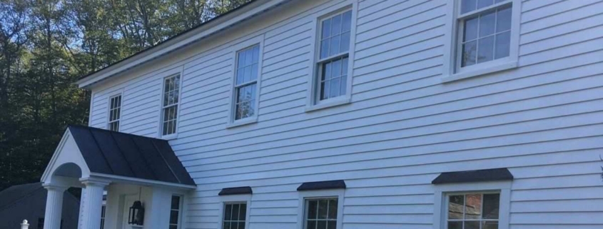 White horizontal clapboard siding covering a two-story house exterior.