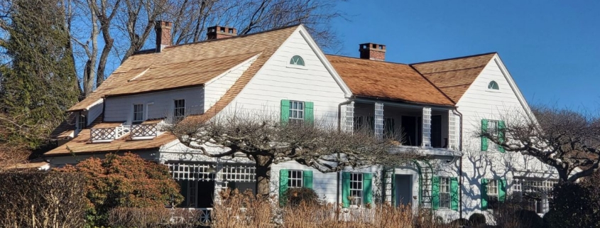 A spacious white house with green shutters set in Niantic.