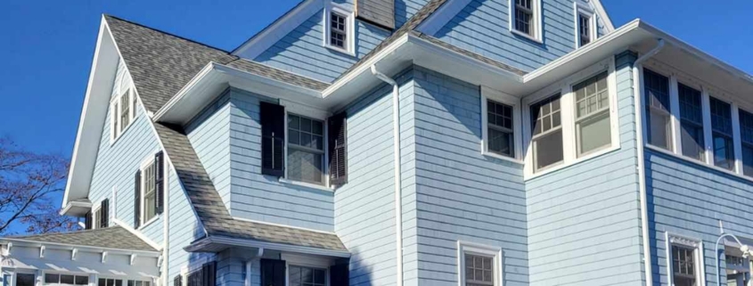 A blue house with white trim and windows located in West Hartford.