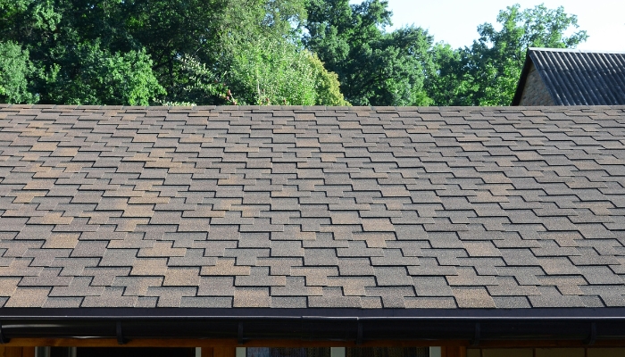 A brown shingled roof, highlighting considerations for replacing asphalt shingles in Connecticut.