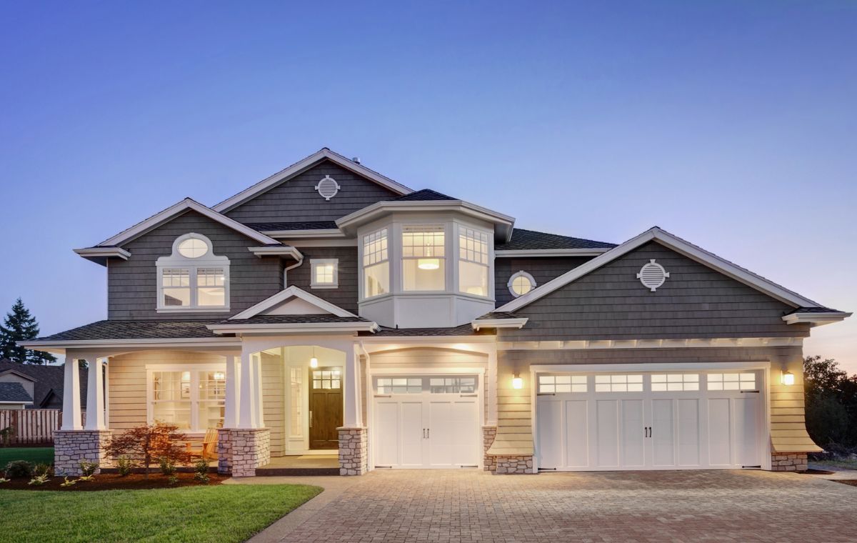 An appealing house with a driveway and garage, showcasing the significance of roof repair in Essex, CT.