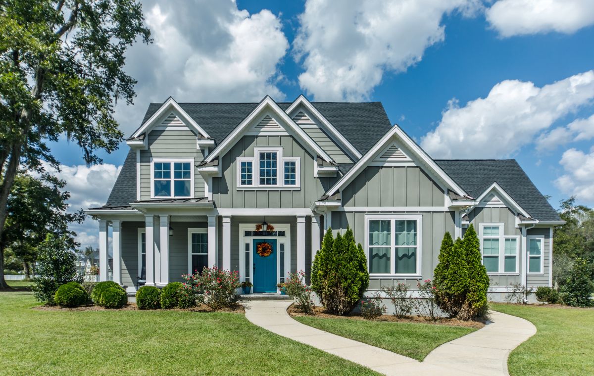 An elegant home with a blue door and white trim, set in Essex, CT, emphasizing its welcoming appearance.