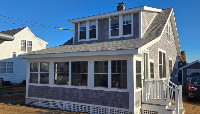 Cape Cod home with gray cedar shingles and white trim