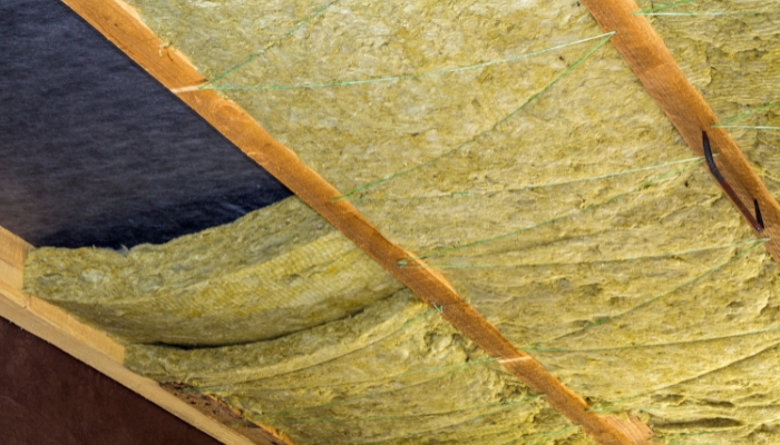 View of attic insulation, emphasizing the need for adequate insulation in Connecticut homes for effective roof repair or replacement.
