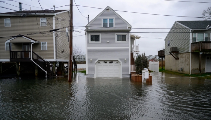 A house partially submerged in flood water, highlighting the impact of storms or hail in Connecticut.