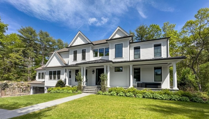 A large white home with a spacious yard, highlighting curb appeal and value for New England properties.