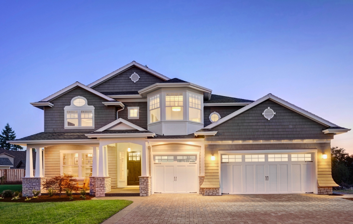 A charming home featuring a driveway and garage, showcasing recent siding replacement CT.