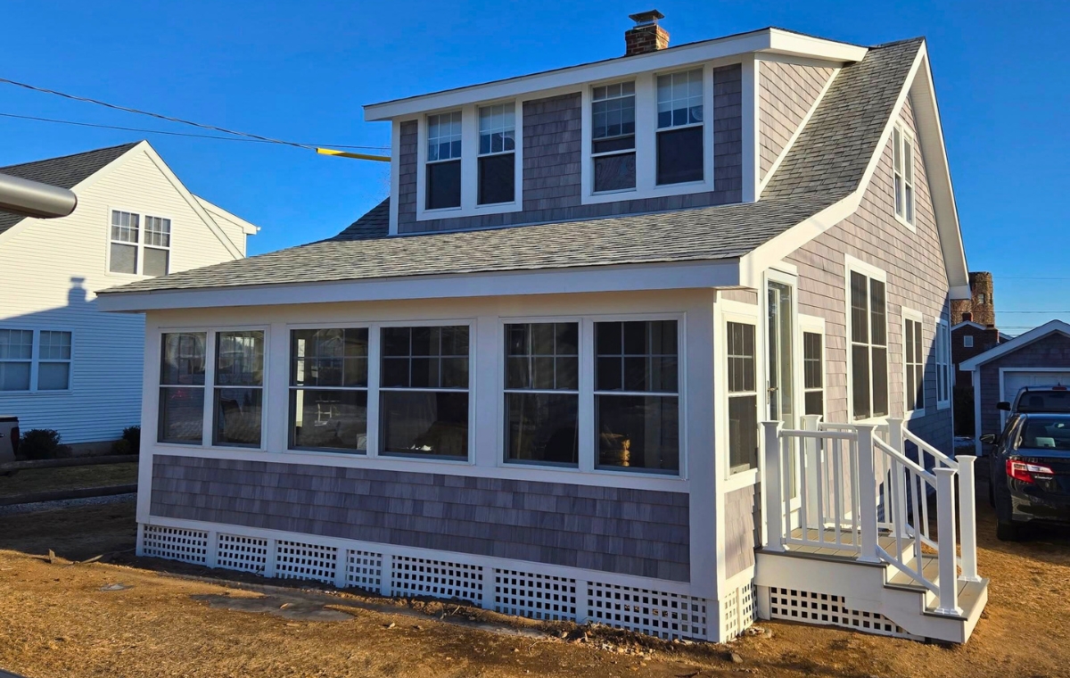Charming house with a porch swing and cedar siding, situated in East Lyme, CT.