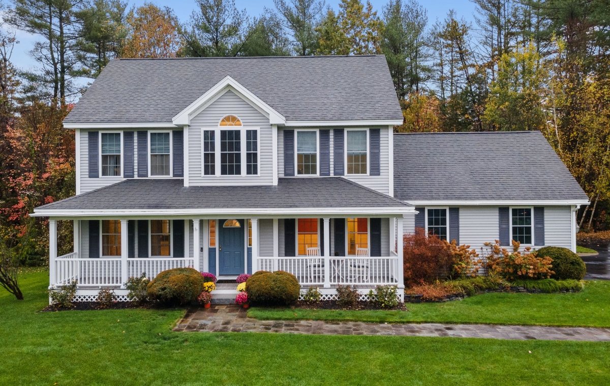 A home with a spacious front yard and large porch, showcasing various siding options in Darien, CT.
