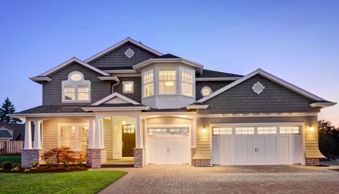 Home with garage highlighting energy-efficient siding.