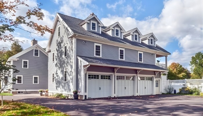 Close-up of weathered and peeling horizontal wood siding on a house, showing significant paint failure and bare wood.