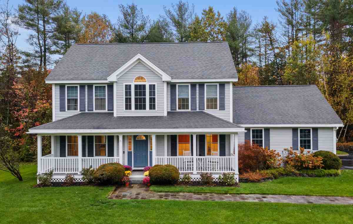 Colonial gray home with wrap-around porch.