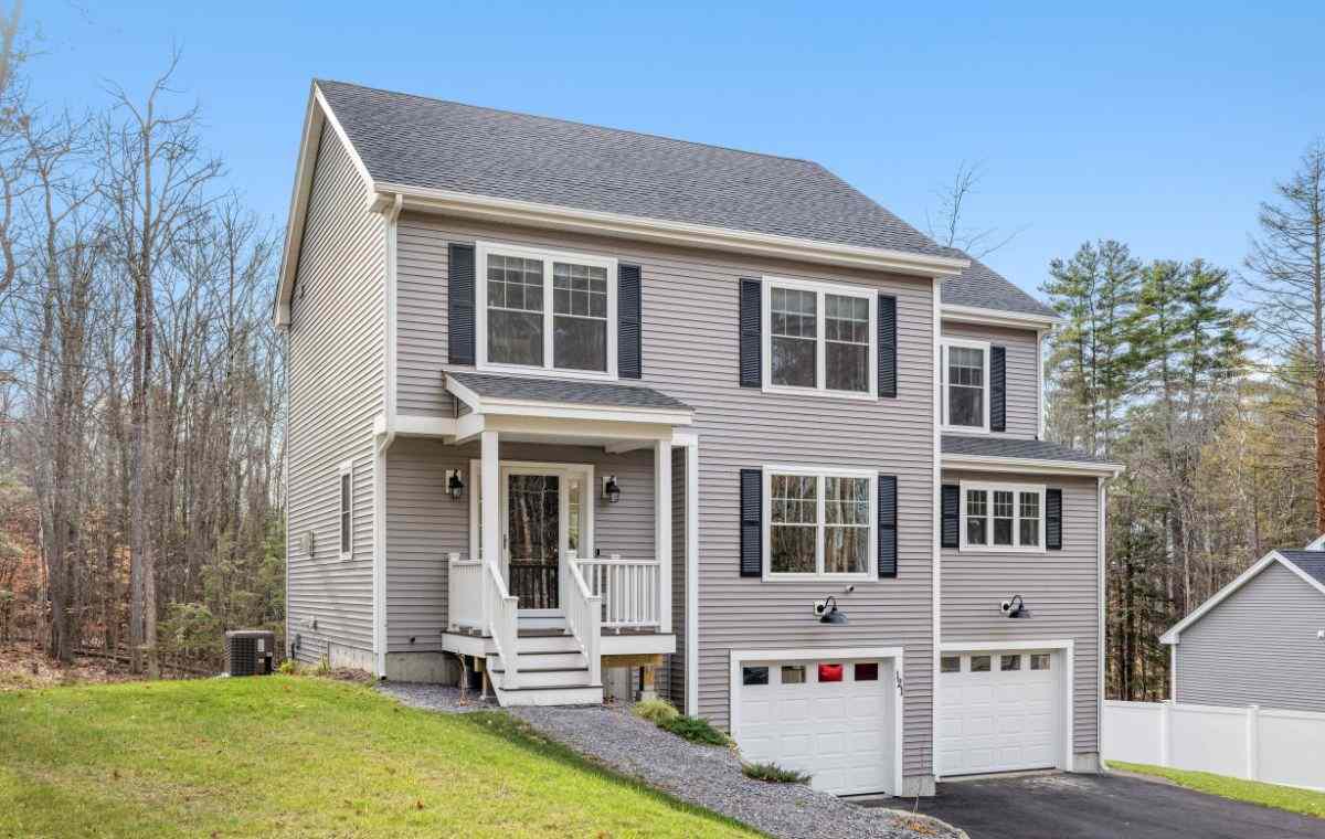 Gray home with navy shutters and white porch.