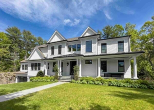 A prominent white house with an expansive yard, highlighting the craftsmanship of a Glastonbury, CT siding contractor.