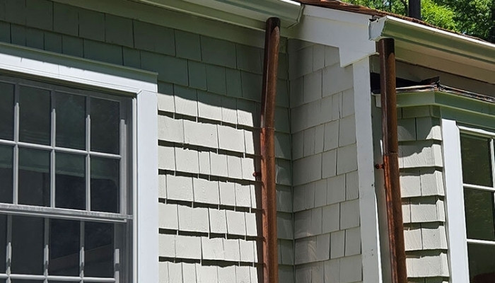 Close-up image of a window frame, illustrating aspects of cedar siding durability and signs for potential replacement.