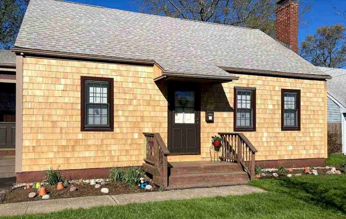 Wood shake siding repair on residential home with updated exterior finish in Connecticut