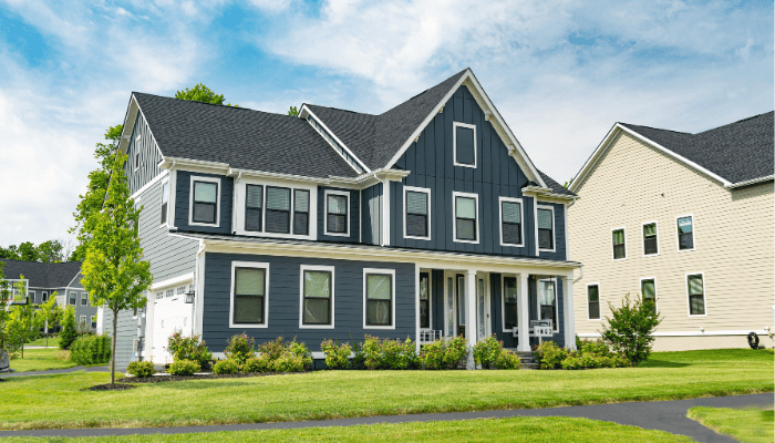 Modern two-story home with dark blue vertical and horizontal siding.