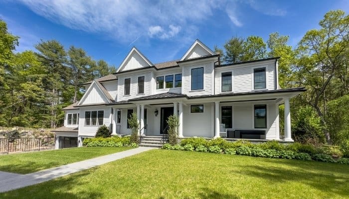 Composite siding in Connecticut with white horizontal siding and dark trim.