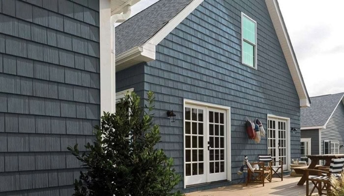 Fiber cement siding in Connecticut with dark gray shingle-style siding and white trim.